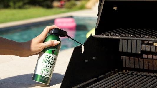 spraying an outdoor BBQ with lubricant