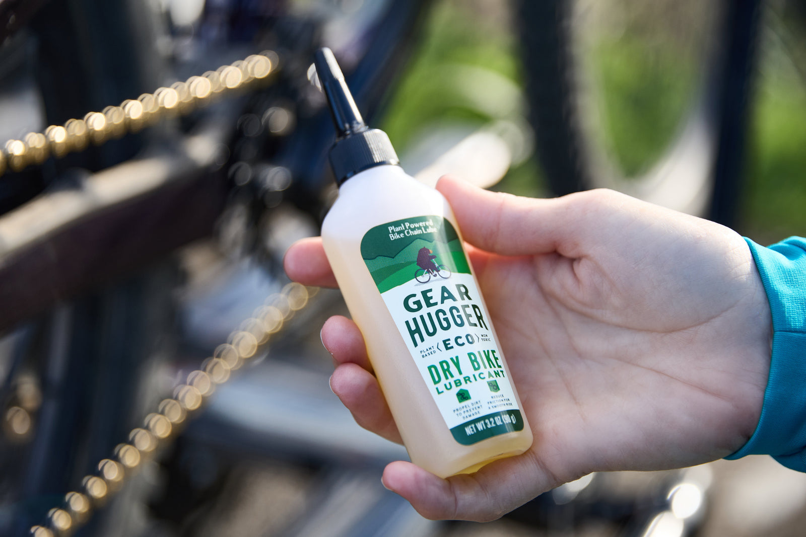 Gear Hugger eco-friendly plant-based bike lubricant being applied to bicycle chain