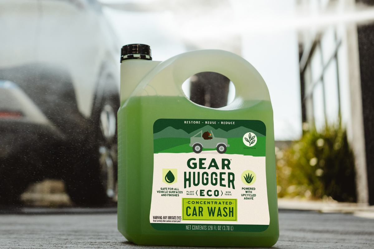 Large jug of Gear Hugger Eco plant-based car wash concentrate on a vehicle outdoors, promoting summer car maintenance tips for adventure ready vehicles
