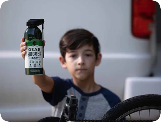 a child holding a can of gear hugger rust protection lubricant