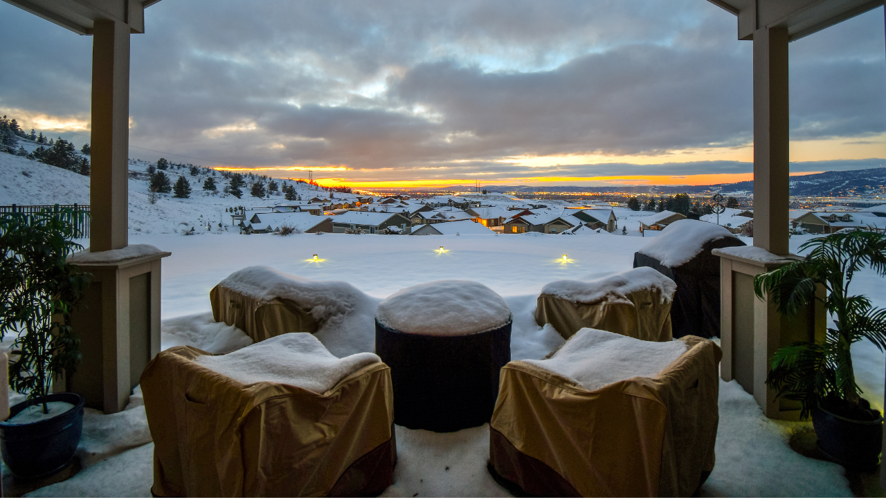 Snow-covered outdoor patio furniture at sunset - winterize with Gear Hugger eco lubricant