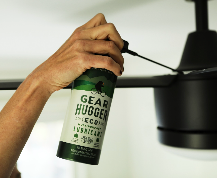 Applying Gear Hugger eco-friendly multipurpose lubricant to a ceiling fan motor