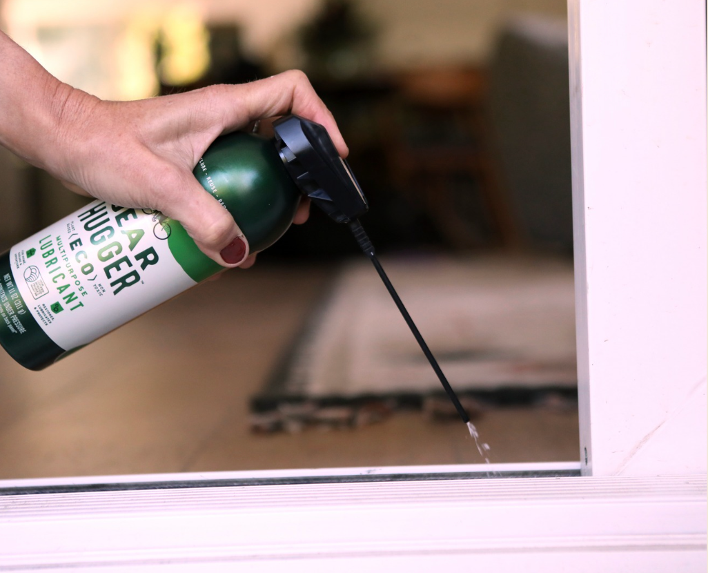 Applying Gear Hugger multipurpose eco lubricant to window sliding door tracks