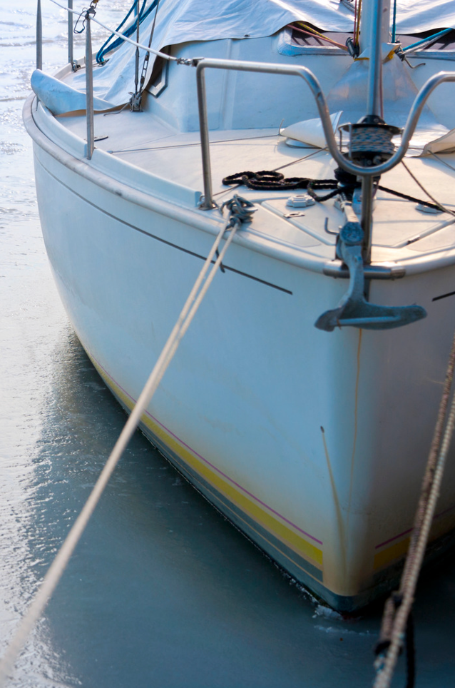 Sailboat docked at marina being winterized with eco-friendly cleaning products