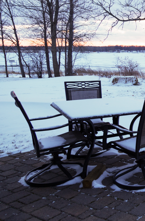 Outdoor patio furniture covered in snow ready for winterization with eco-friendly products