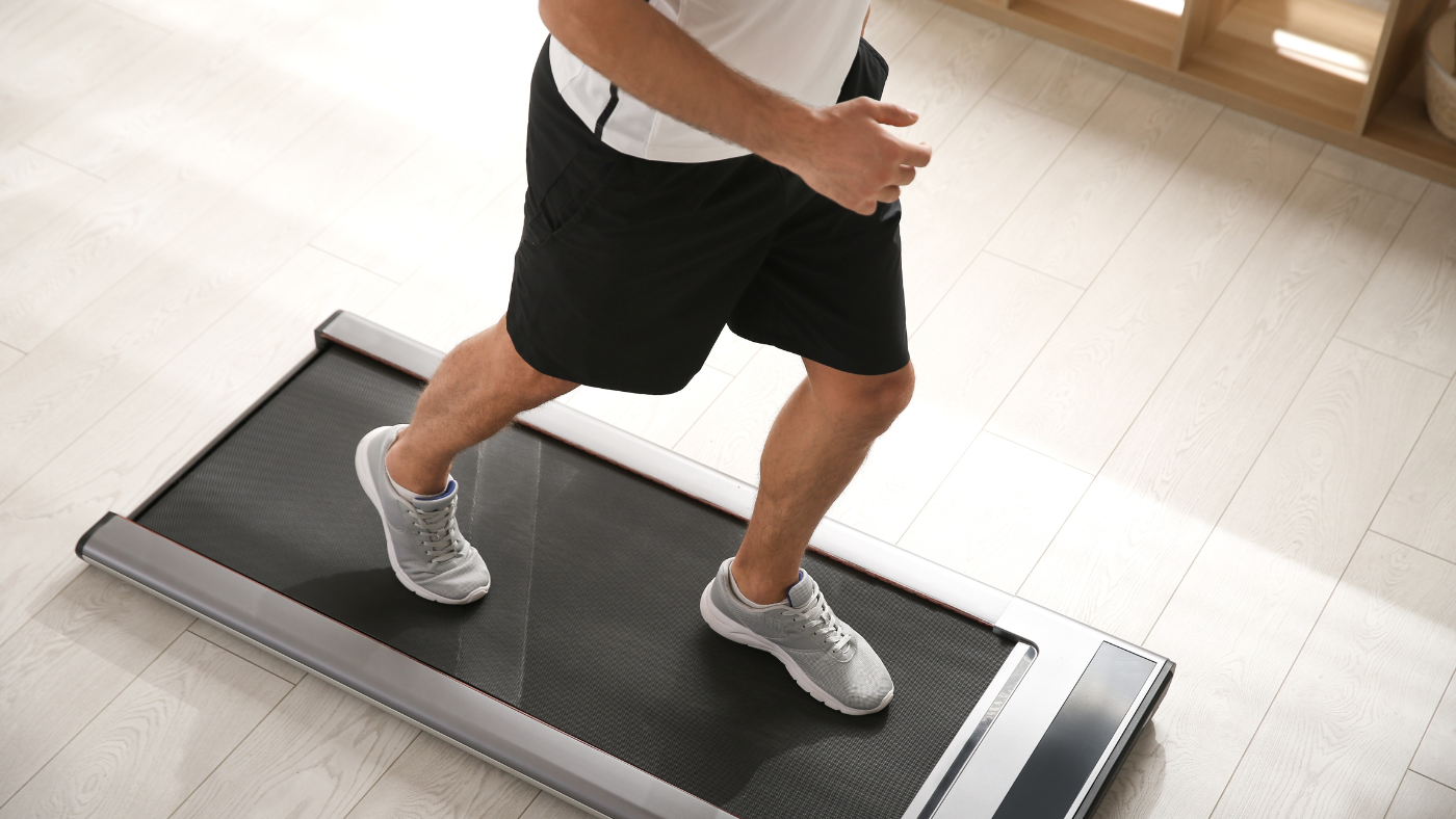 Person running on a treadmill being lubricated with Gear Hugger eco-friendly lubricant