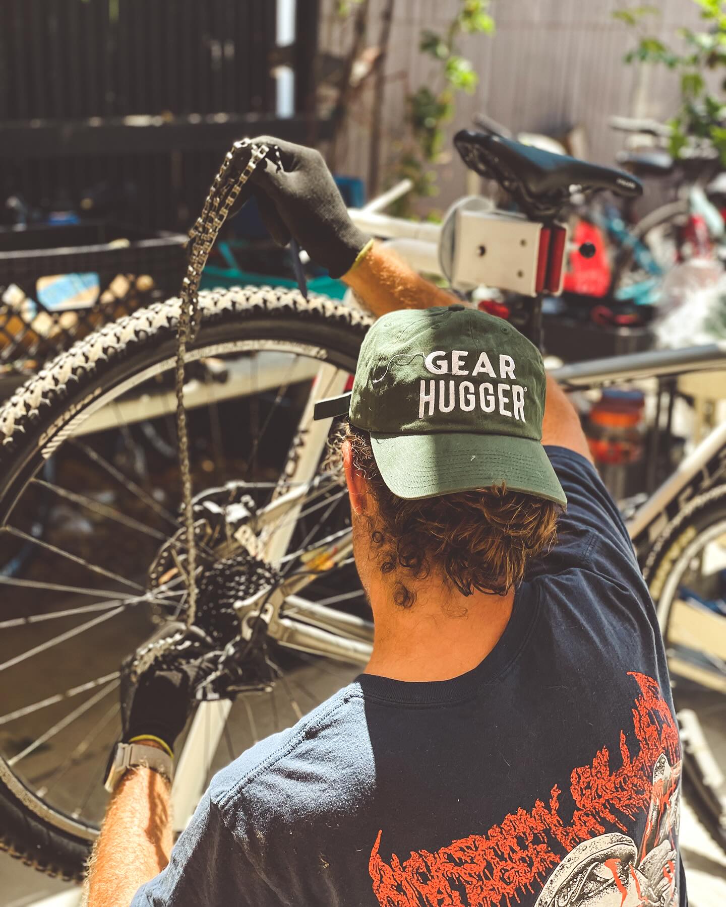 bike mechanic lubricating a bike chain