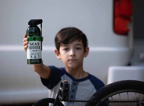 child holding a bottle of Gear Hugger