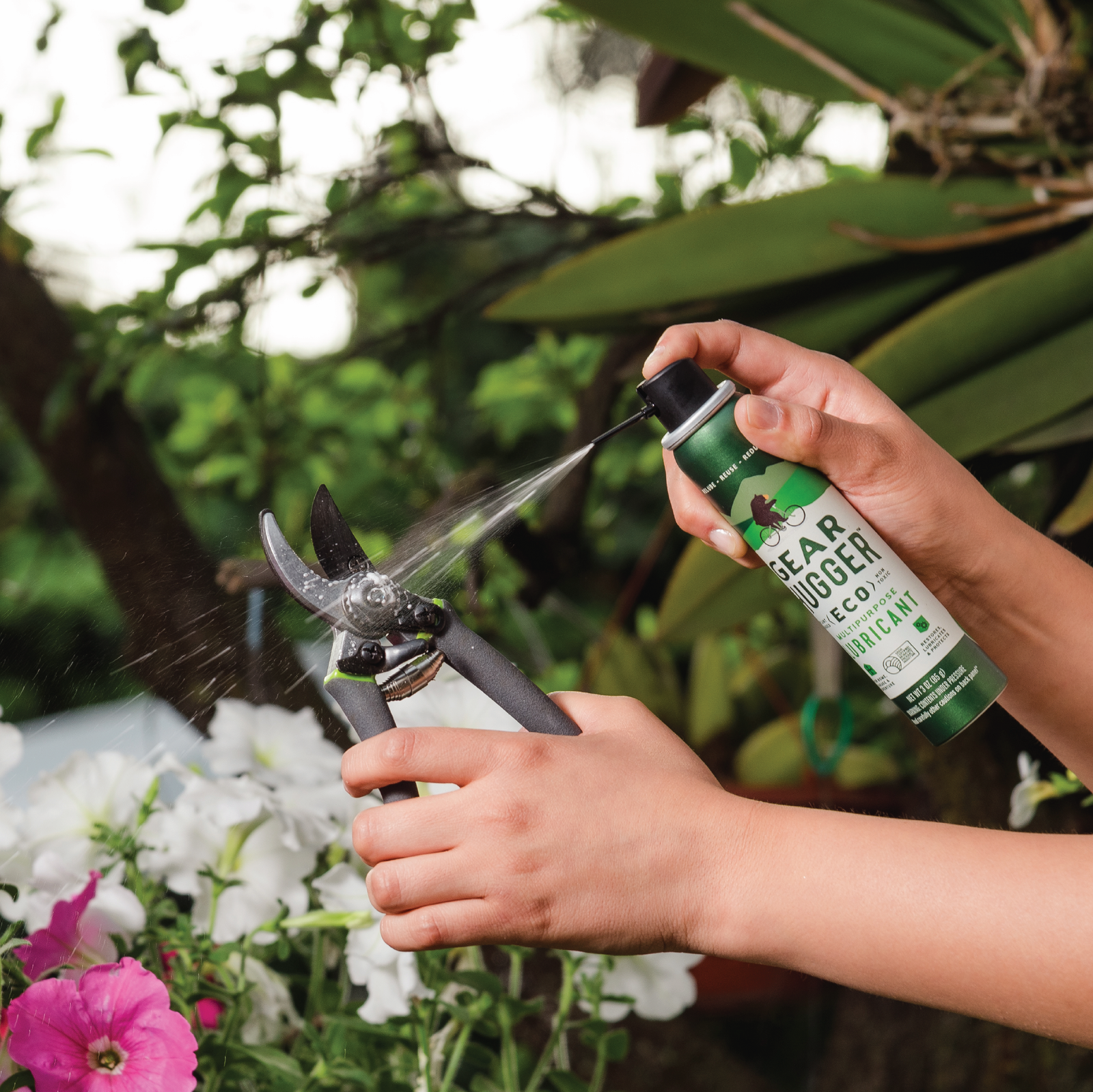 grease spray being used on outdoor yard clippers