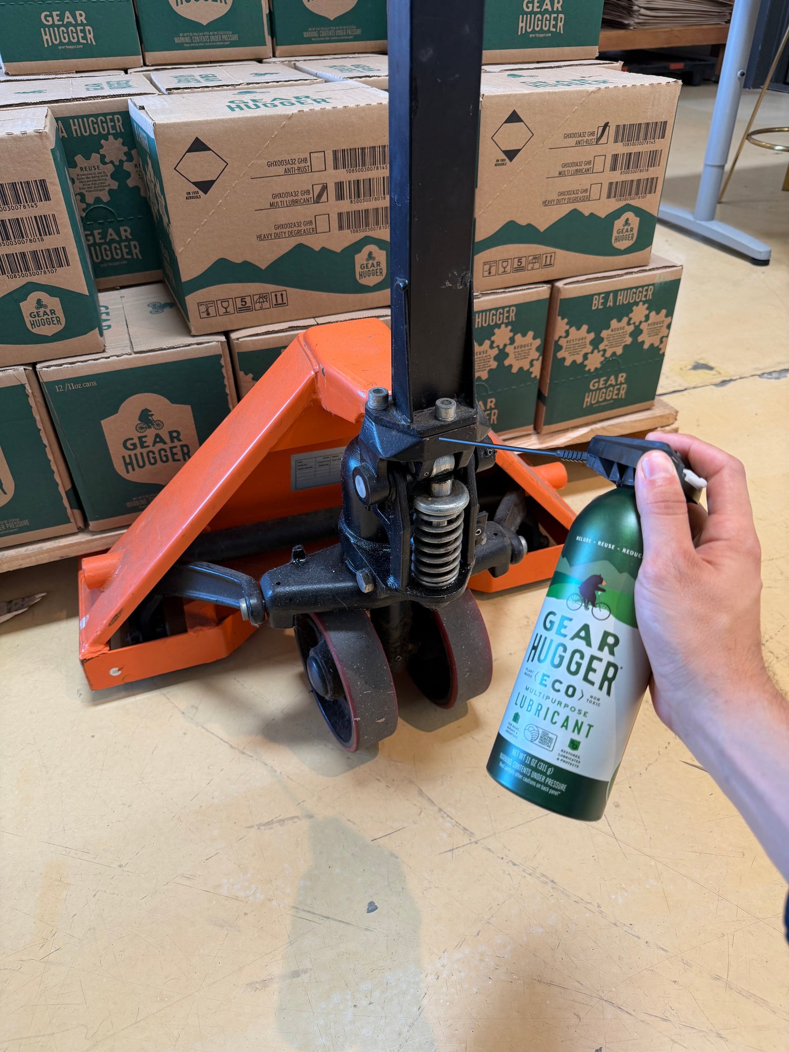 lubricating a pallet jack with a grease spray