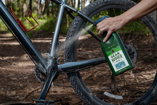 spraying bike with bike wash 