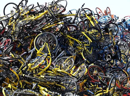 stack of rusty bicycles dumped