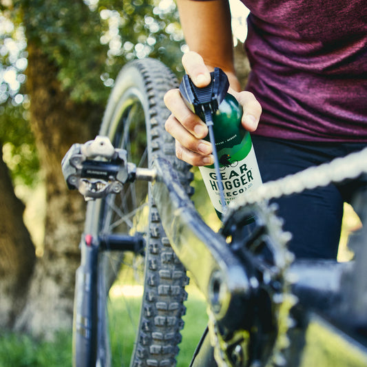 spraying lubricant on a bike chain