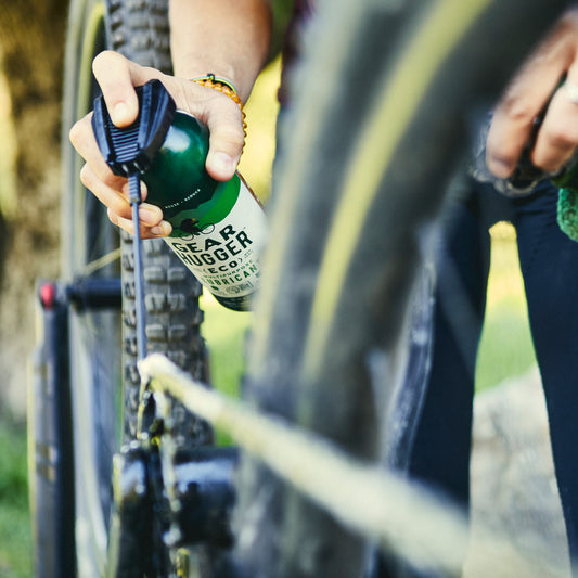 spraying grease on a bicycle to eliminate rust